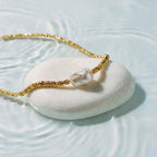 Helena George. Gold bracelet with a pearl on a white stone